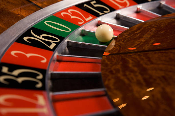 Live dealer studio with roulette wheel and gaming tables at disinitoto login